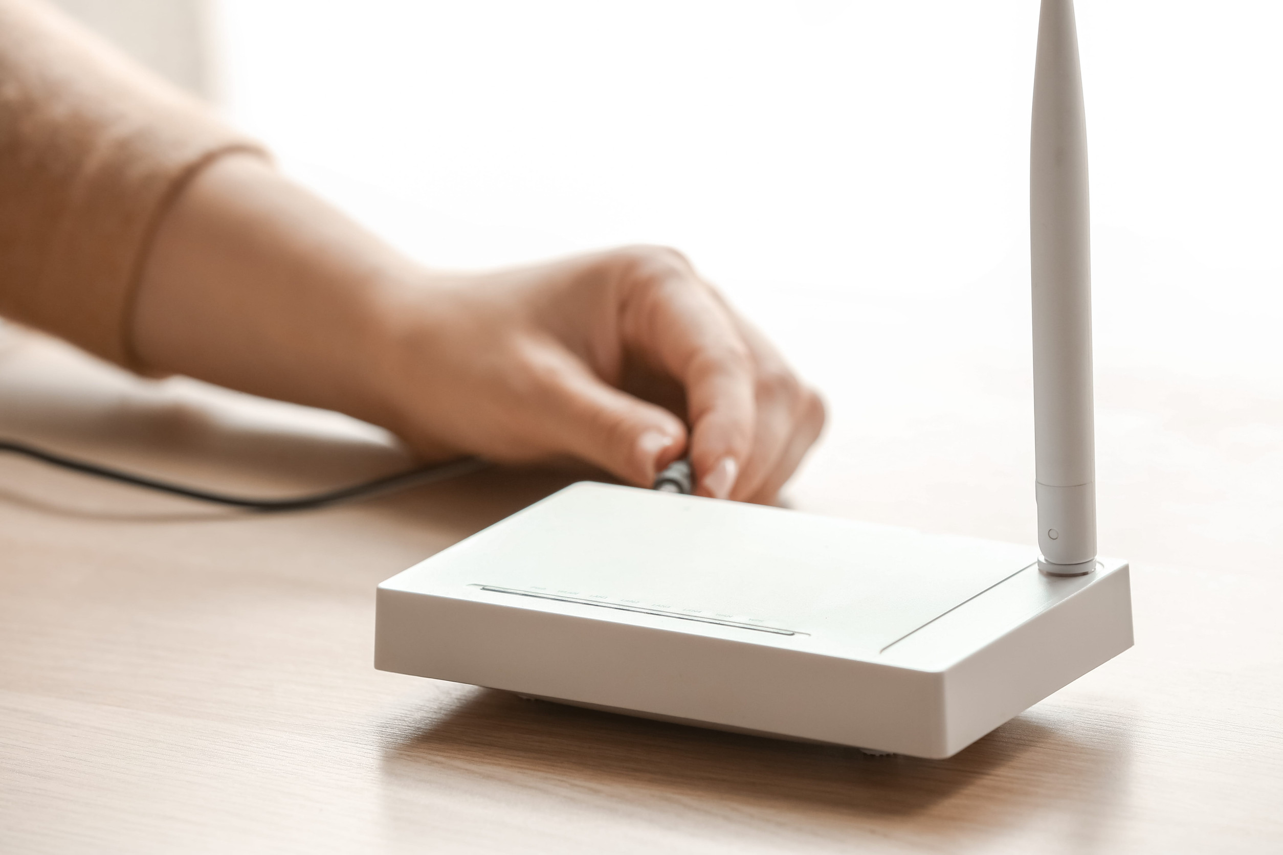 Person Connecting A Cable To A High-Speed Internet Router For Business Network Access